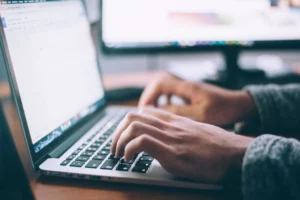 Person typing on keyboard